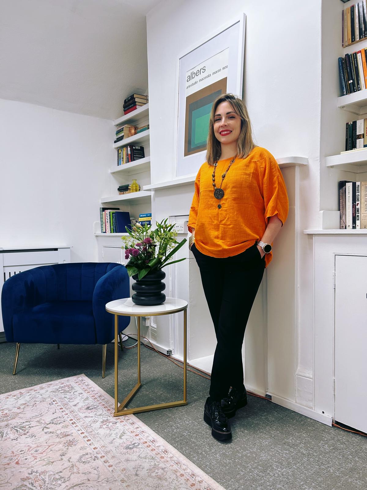Caroline Silvestre portrait against a green textured wall